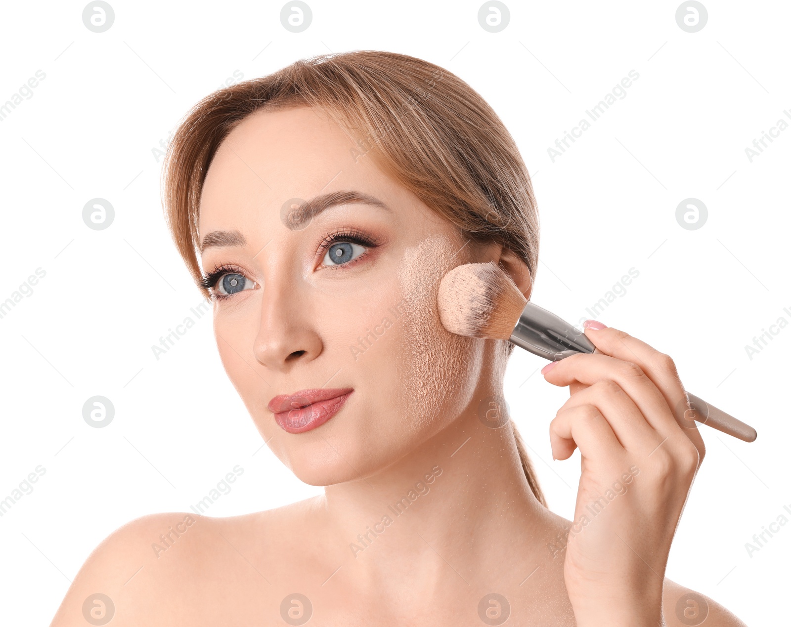 Photo of Beautiful young woman applying face powder with brush on white background