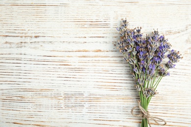 Photo of Blooming lavender flowers on wooden background, top view