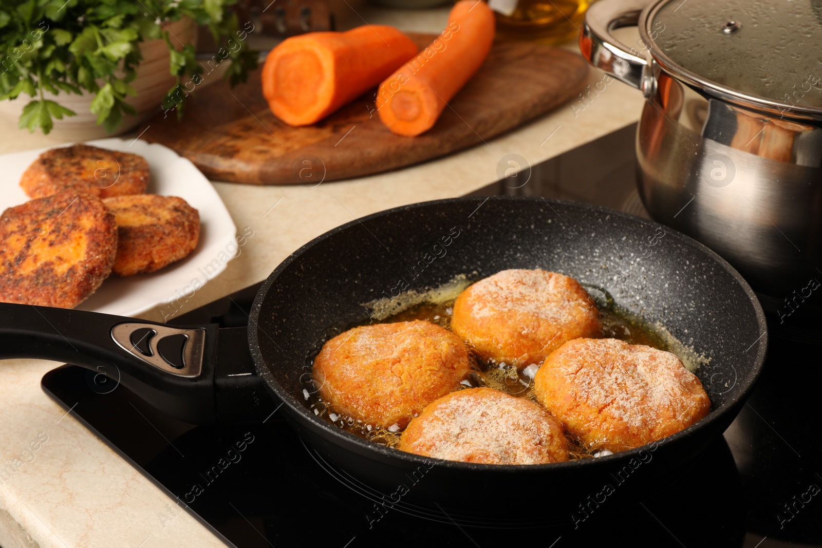 Photo of Cooking vegan cutlets in frying pan on stove