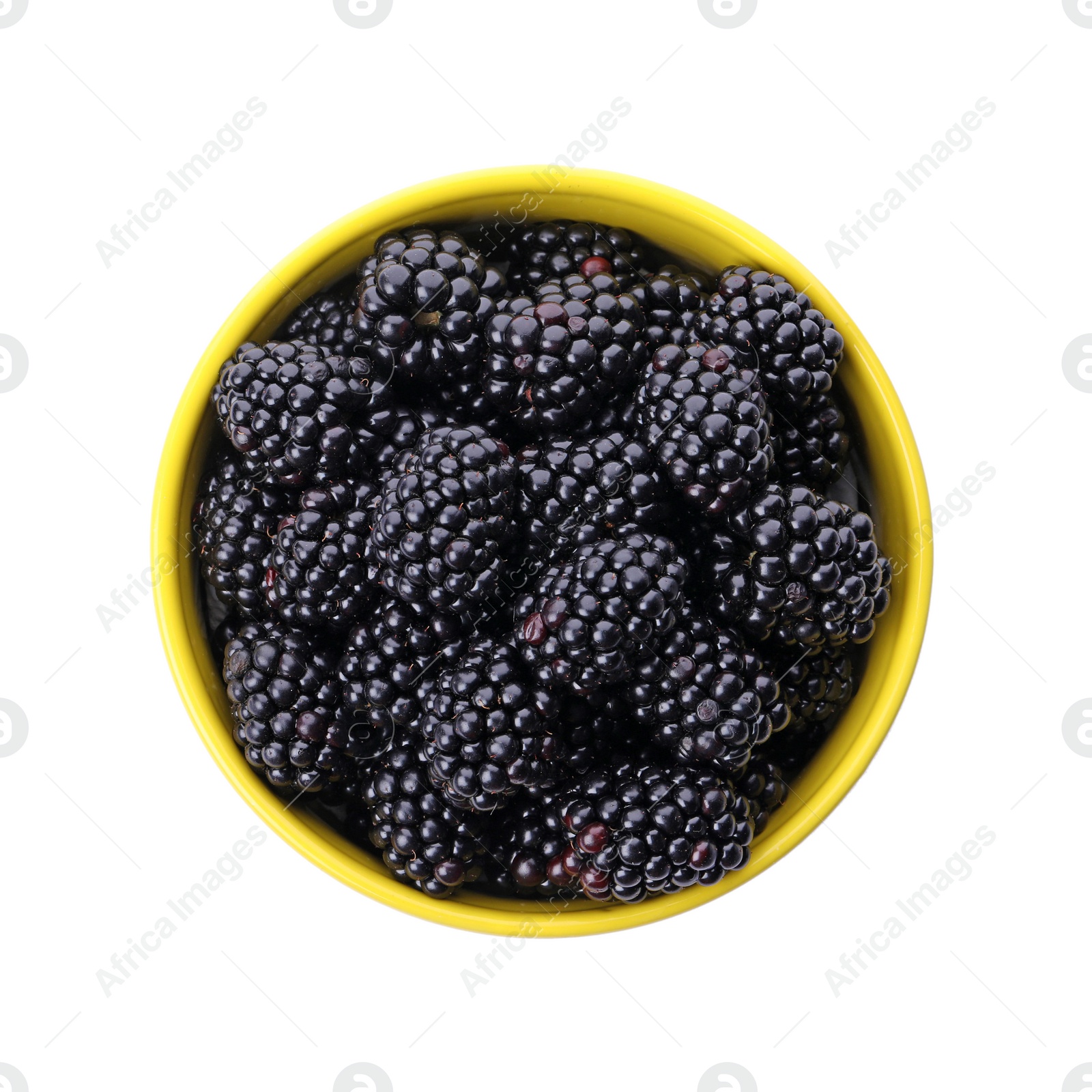 Photo of Yellow bowl of tasty ripe blackberries on white background, top view