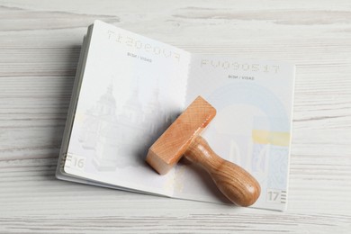 Ukraine, Lviv - September 6, 2022: Passport and visa stamp on white wooden table, top view