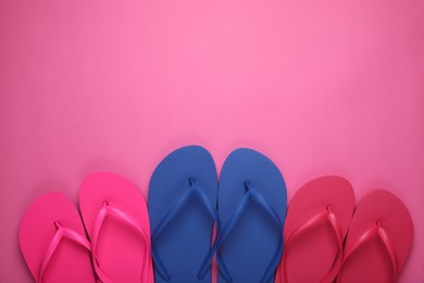 Photo of Different stylish flip flops on pink background, flat lay. Space for text
