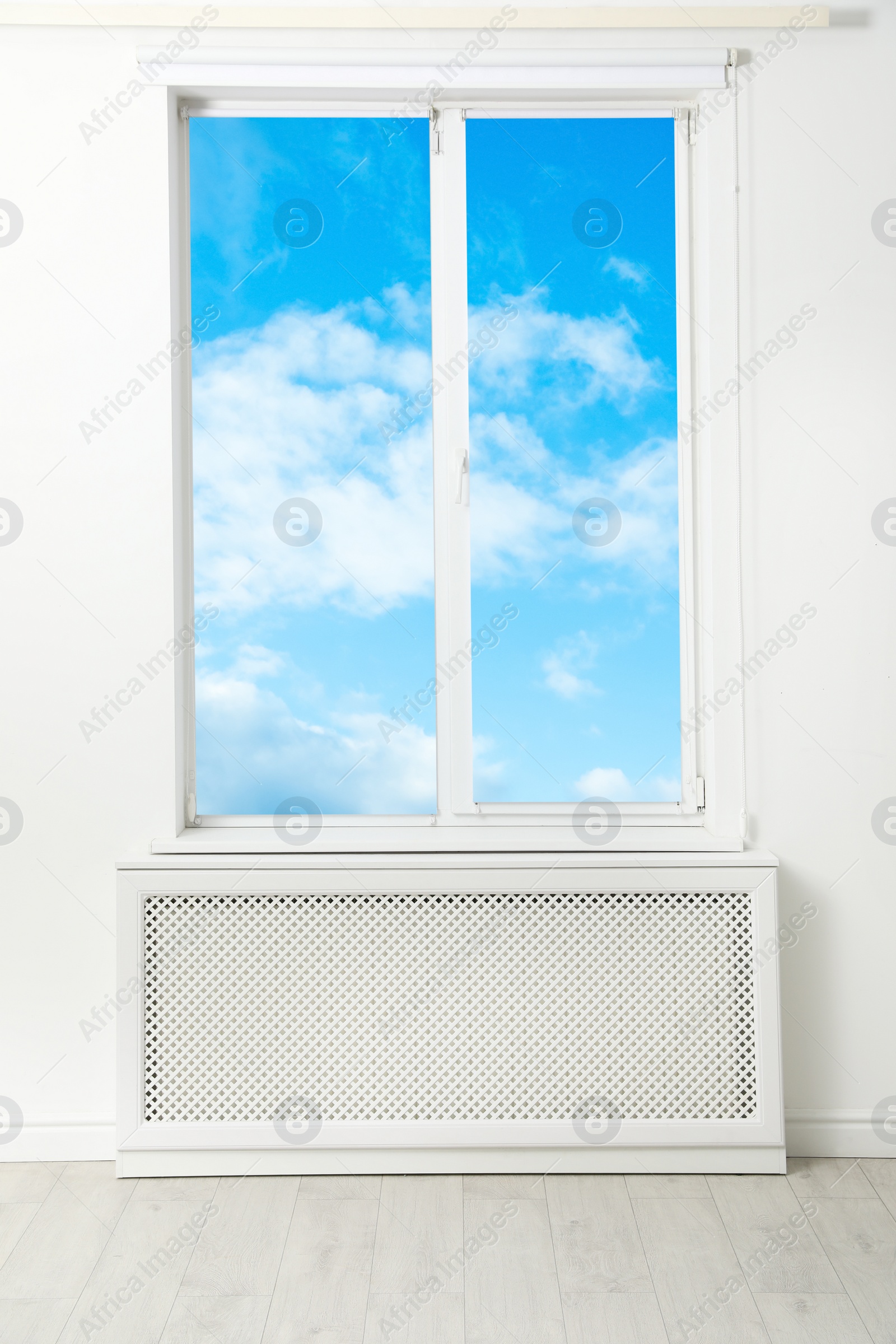 Image of Beautiful view on blue sky with clouds through window in room