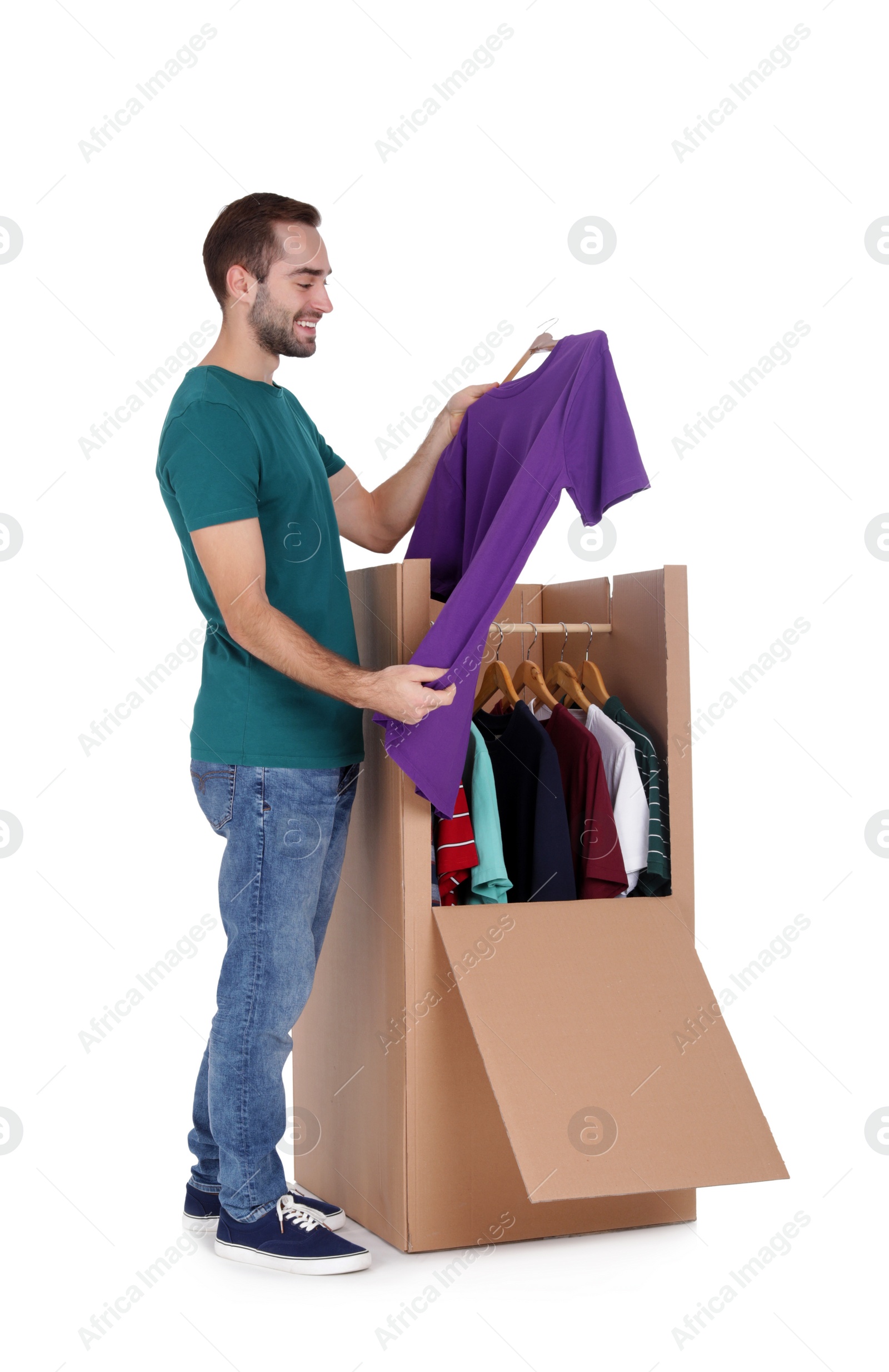 Photo of Young man near wardrobe box on white background