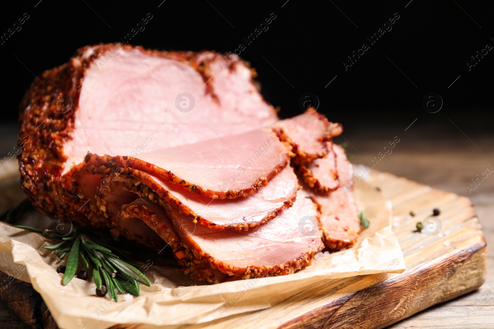 Photo of Delicious ham on wooden table against black background. Christmas dinner