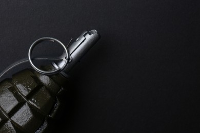 Photo of Hand grenade on black background, closeup. Space for text