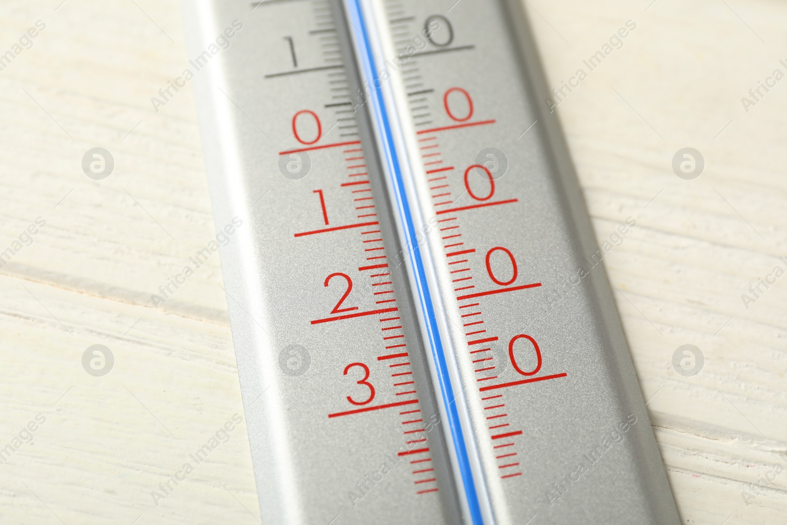 Photo of Modern weather thermometer on white wooden background, closeup