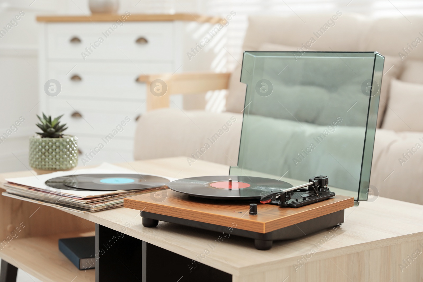 Photo of Turntable with vinyl record in living room