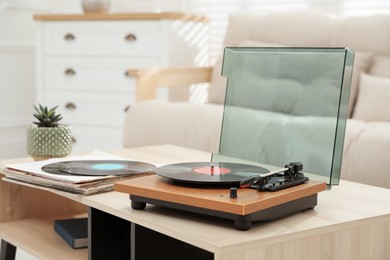 Photo of Turntable with vinyl record in living room