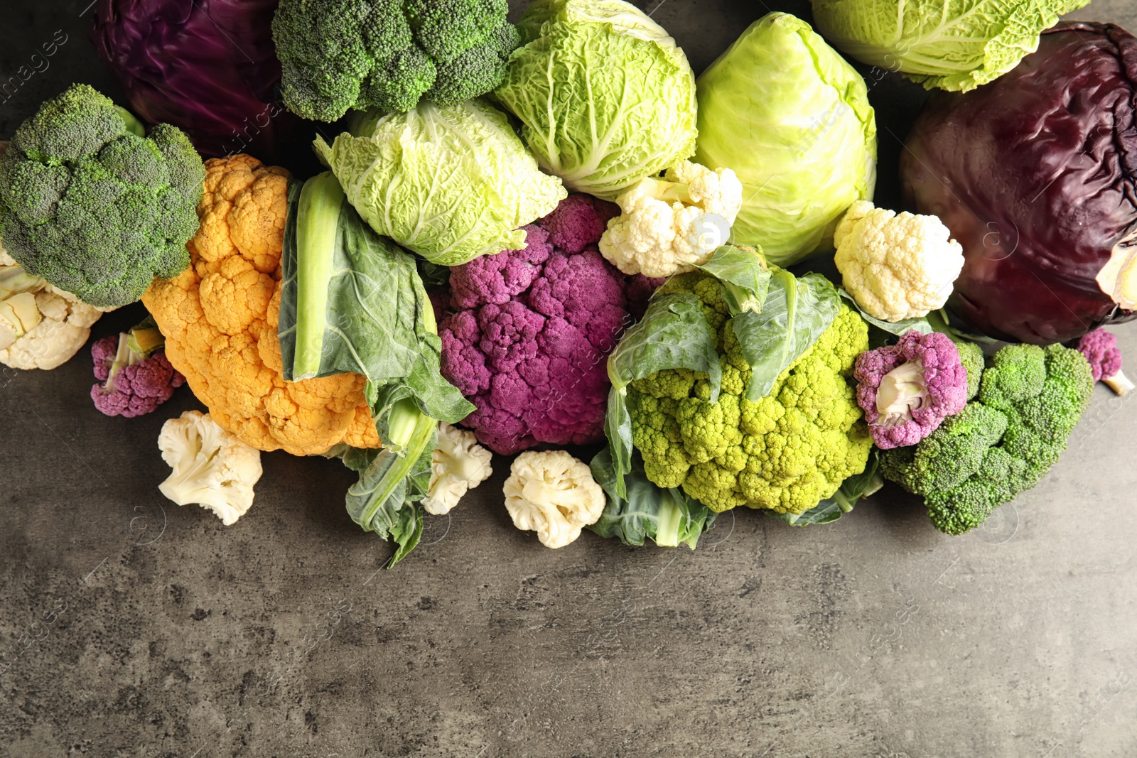 Photo of Different fresh cabbages on table, top view. Healthy food