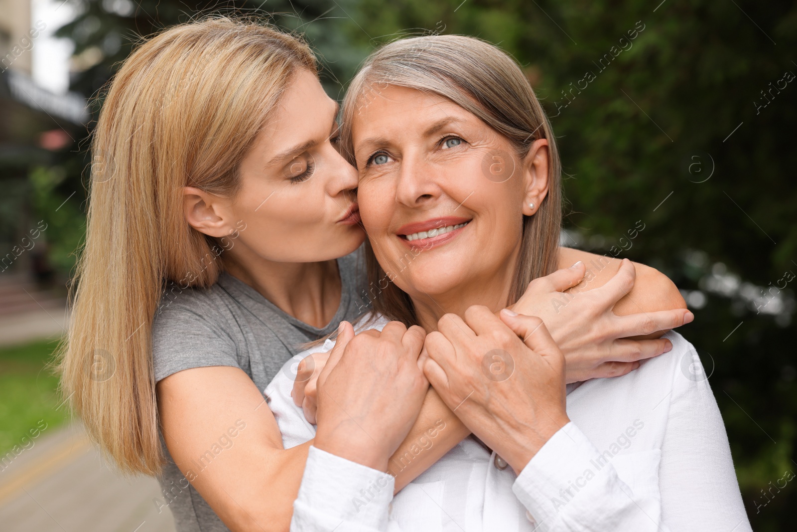 Photo of Happy mature mother and her daughter outdoors