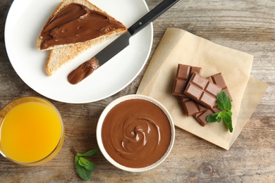 Sweet chocolate mousse and juice served on wooden table, flat lay