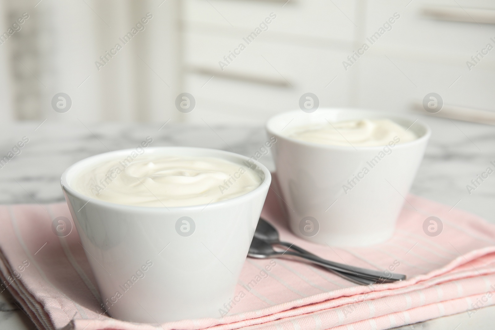 Photo of Tasty organic yogurt on table indoors. Space for text