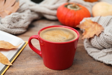 Photo of Cup of hot drink on wooden table. Cozy autumn atmosphere