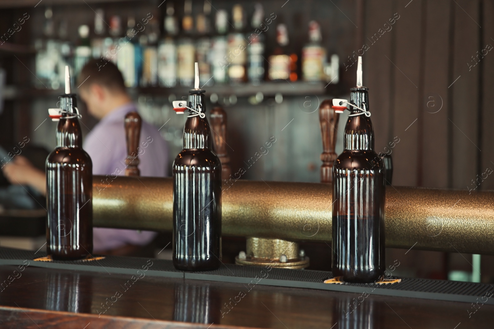 Photo of Bottles on counter in modern beer bar