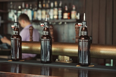 Photo of Bottles on counter in modern beer bar