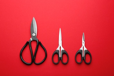 Set of different scissors on color background, flat lay