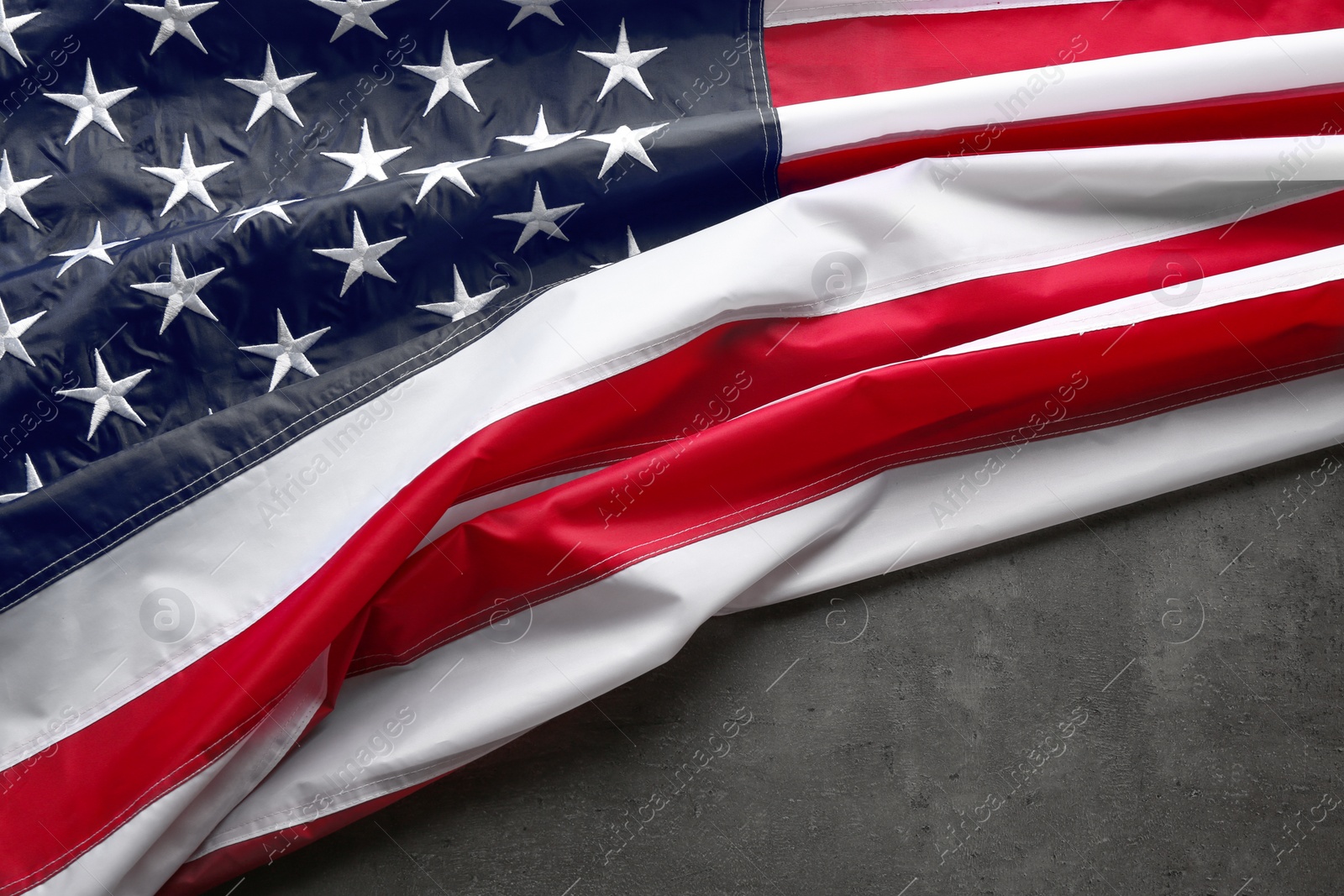 Photo of American flag on grey background, space for text