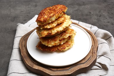 Stack of tasty parsnip cutlets on grey textured table
