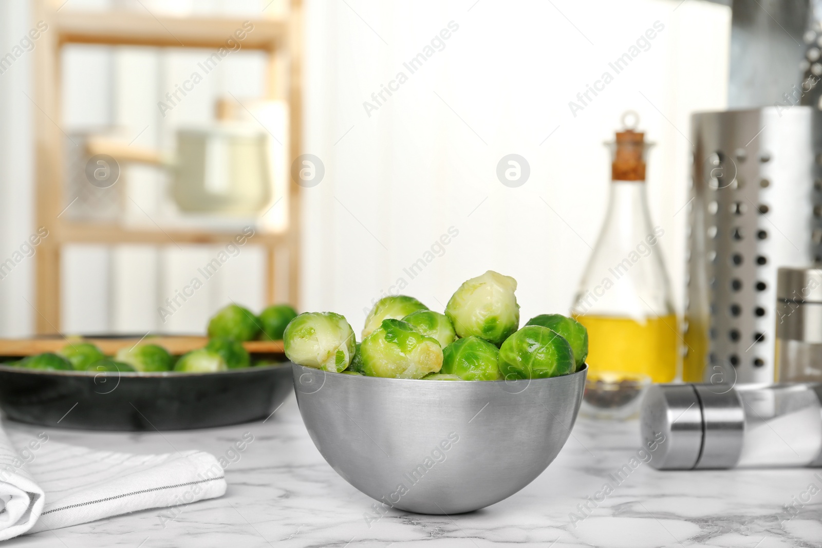 Photo of Bowl with frozen brussel sprouts on table. Vegetable preservation