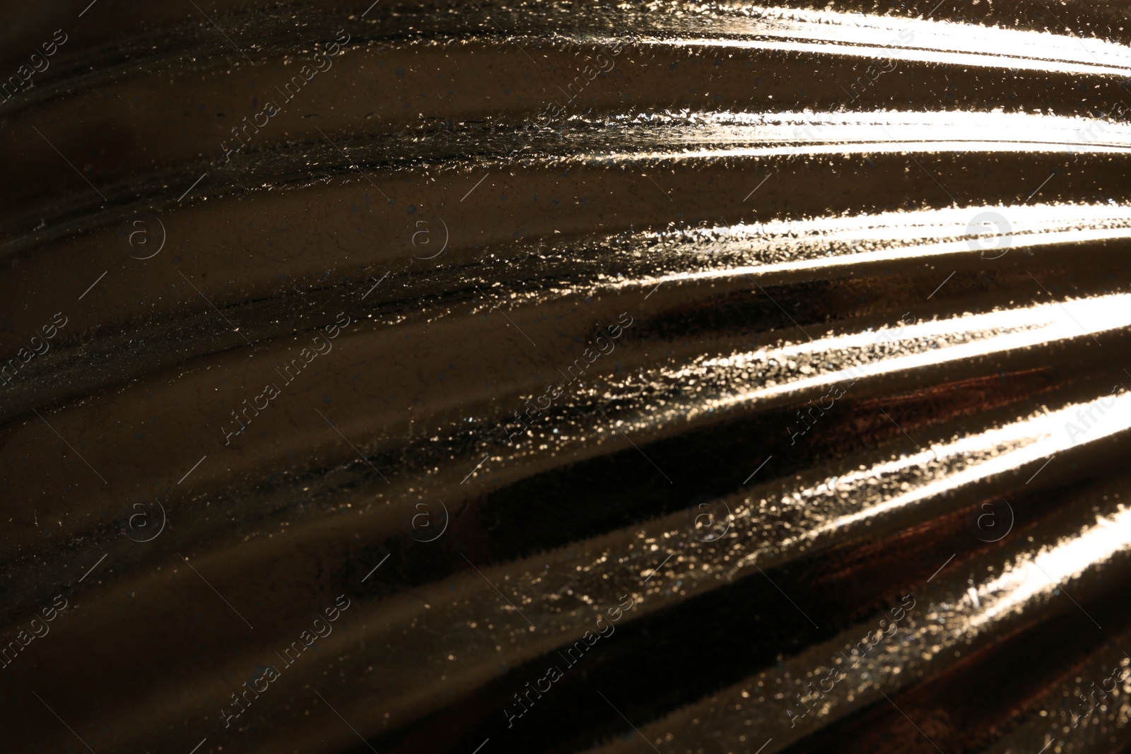 Photo of Corrugated golden texture as background, closeup view