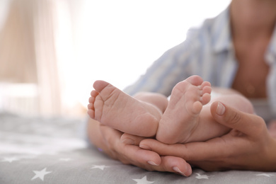 Photo of Mother and her little baby on bed, closeup