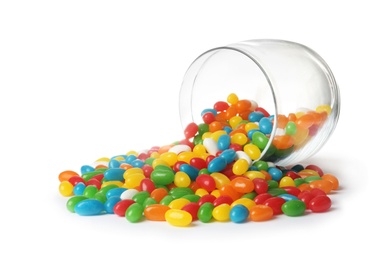 Photo of Glass jar and scattered bright jelly beans isolated on white