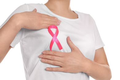 Woman with pink ribbon on white background, closeup. Breast cancer awareness