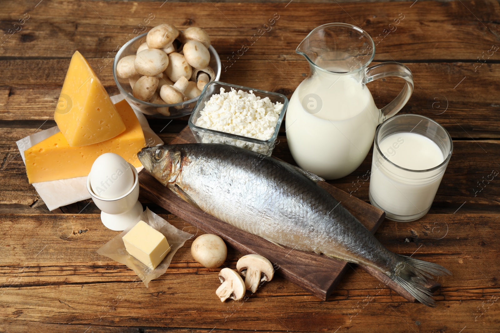 Photo of Fresh products rich in vitamin D on wooden table