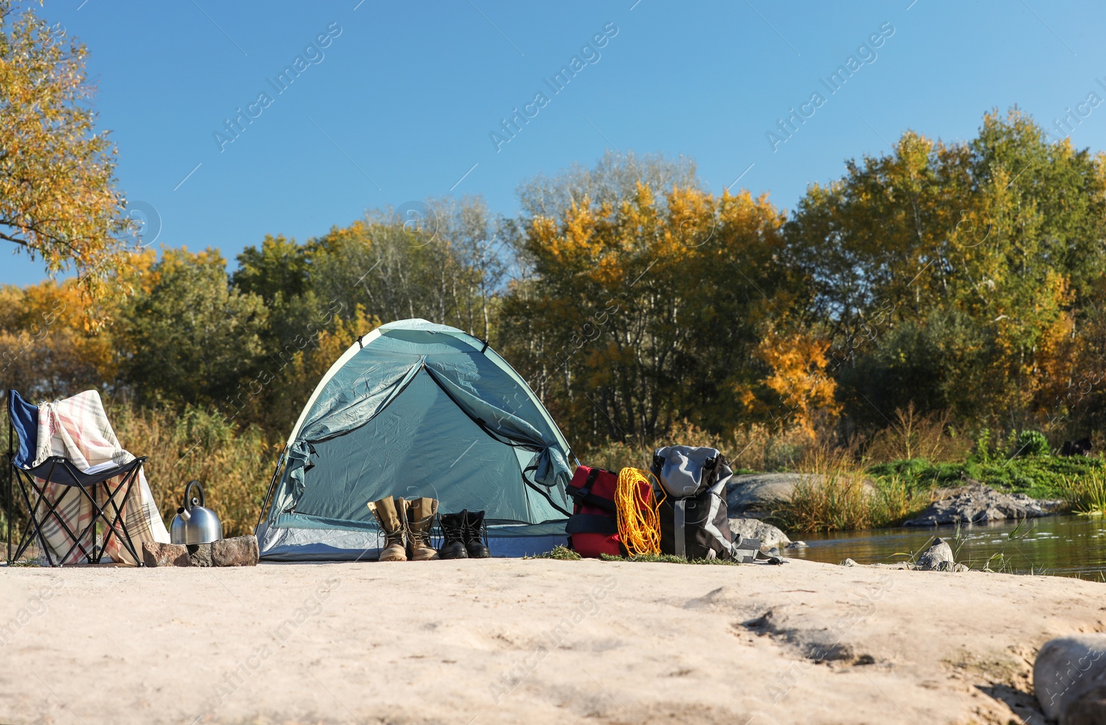 Photo of Set of equipment near camping tent outdoors