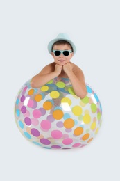 Cute little child with inflatable ball on white background. Beach holiday