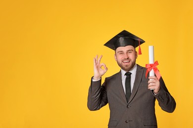 Photo of Happy student with graduation hat and diploma on yellow background. Space for text