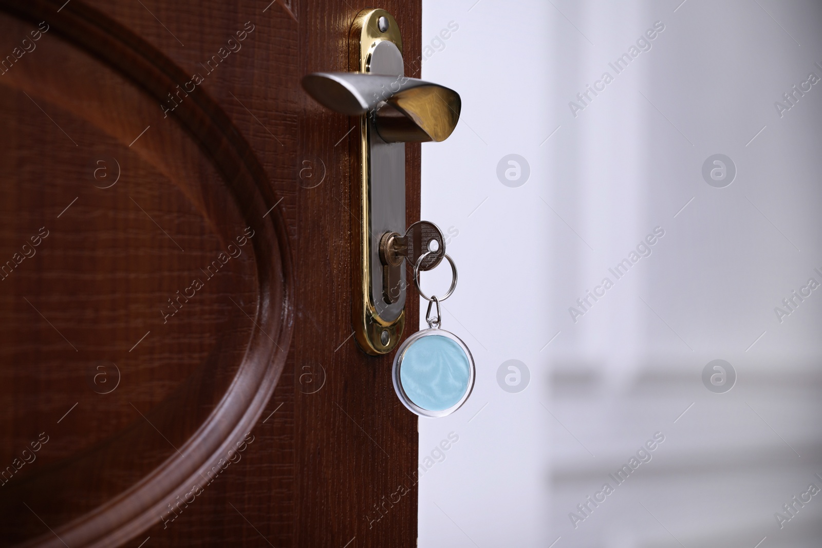 Photo of Closeup view of door with key in room, space for text