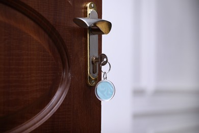 Closeup view of door with key in room, space for text