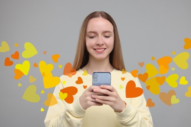 Image of Long distance love. Woman chatting with sweetheart via smartphone on grey background. Hearts flying out of device