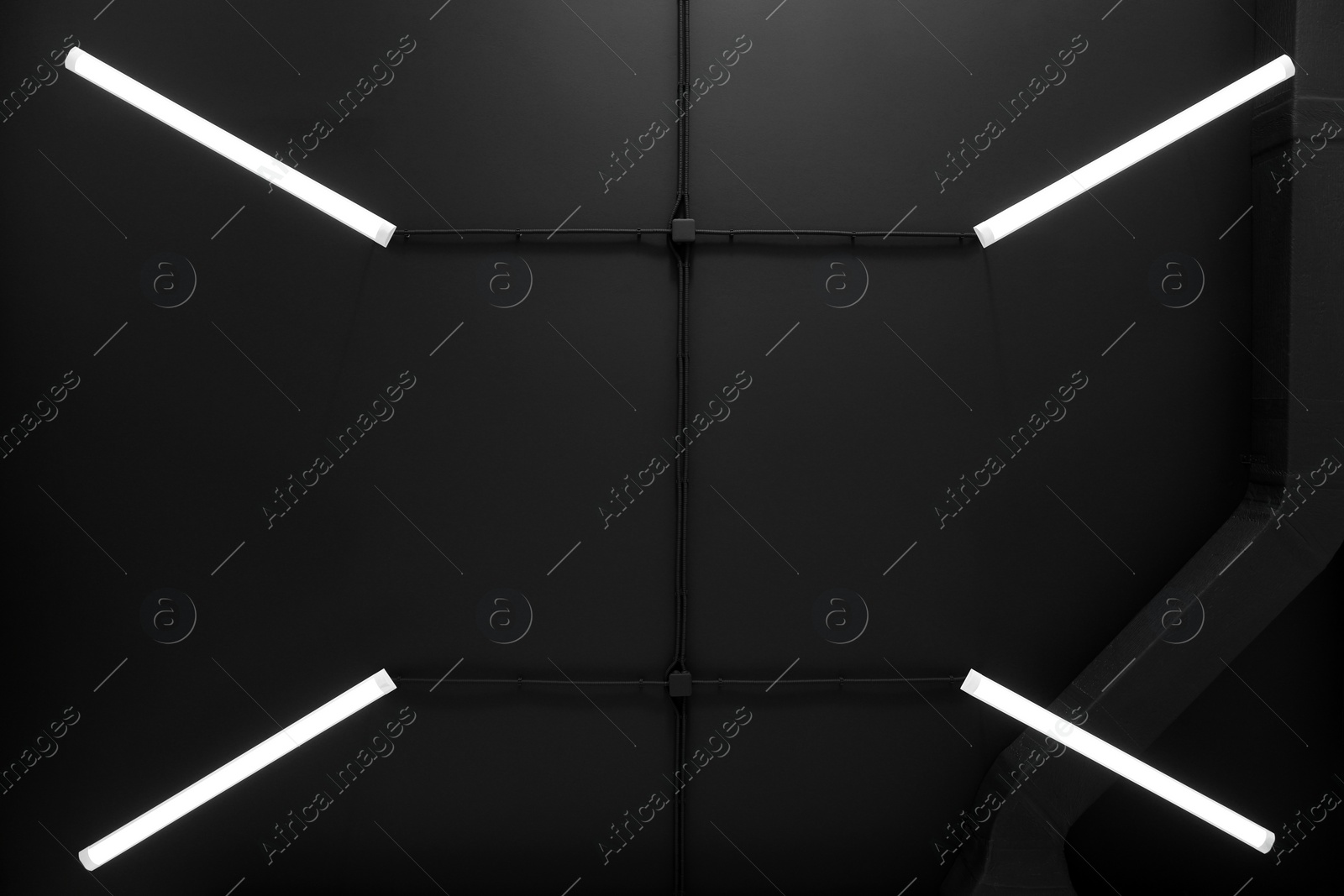 Photo of Black ceiling with modern lighting in room, bottom view