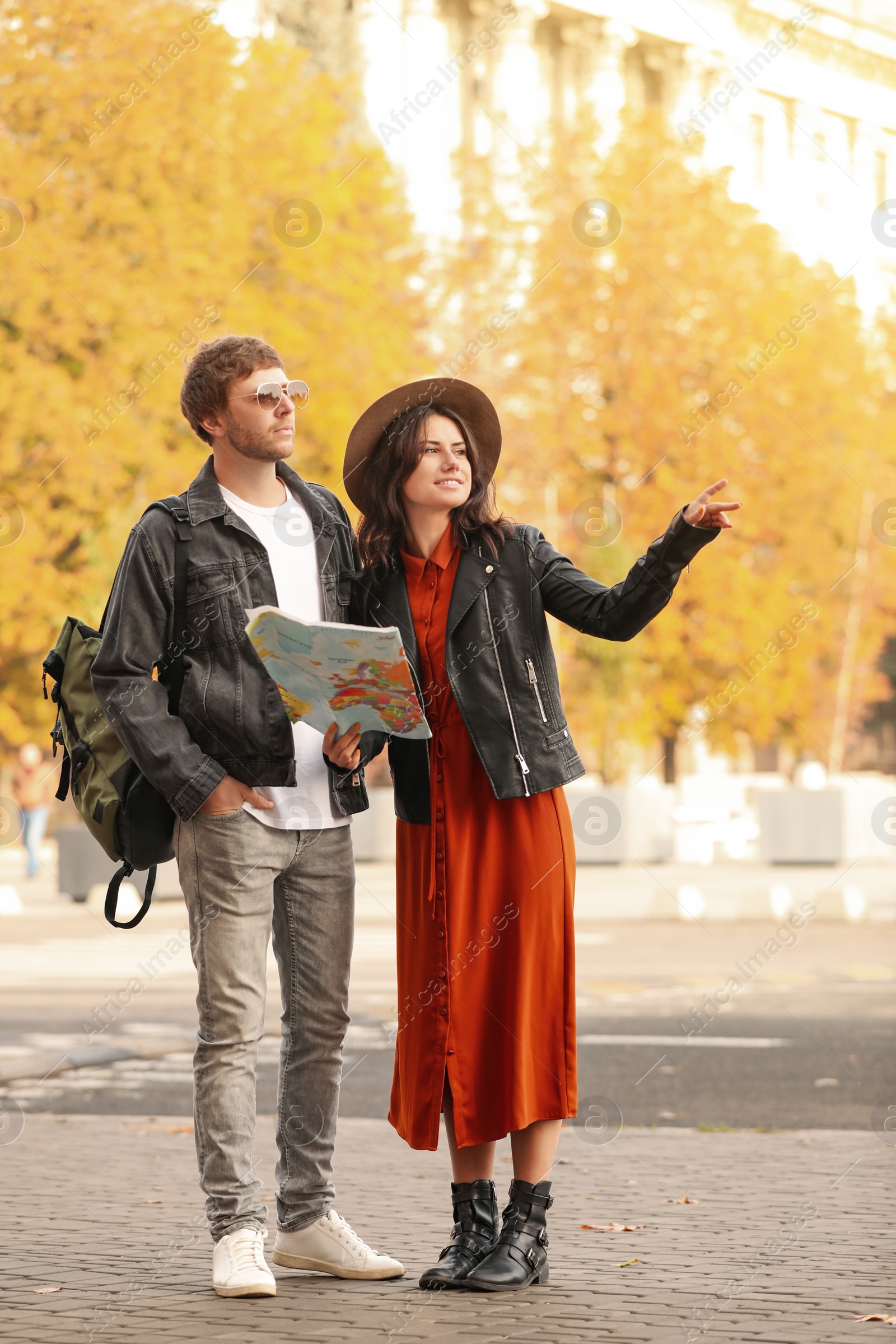 Photo of Couple of travelers with map on city street