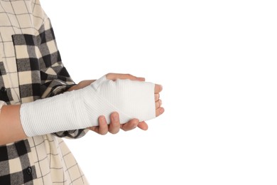 Photo of Woman with hand wrapped in medical bandage on white background, closeup