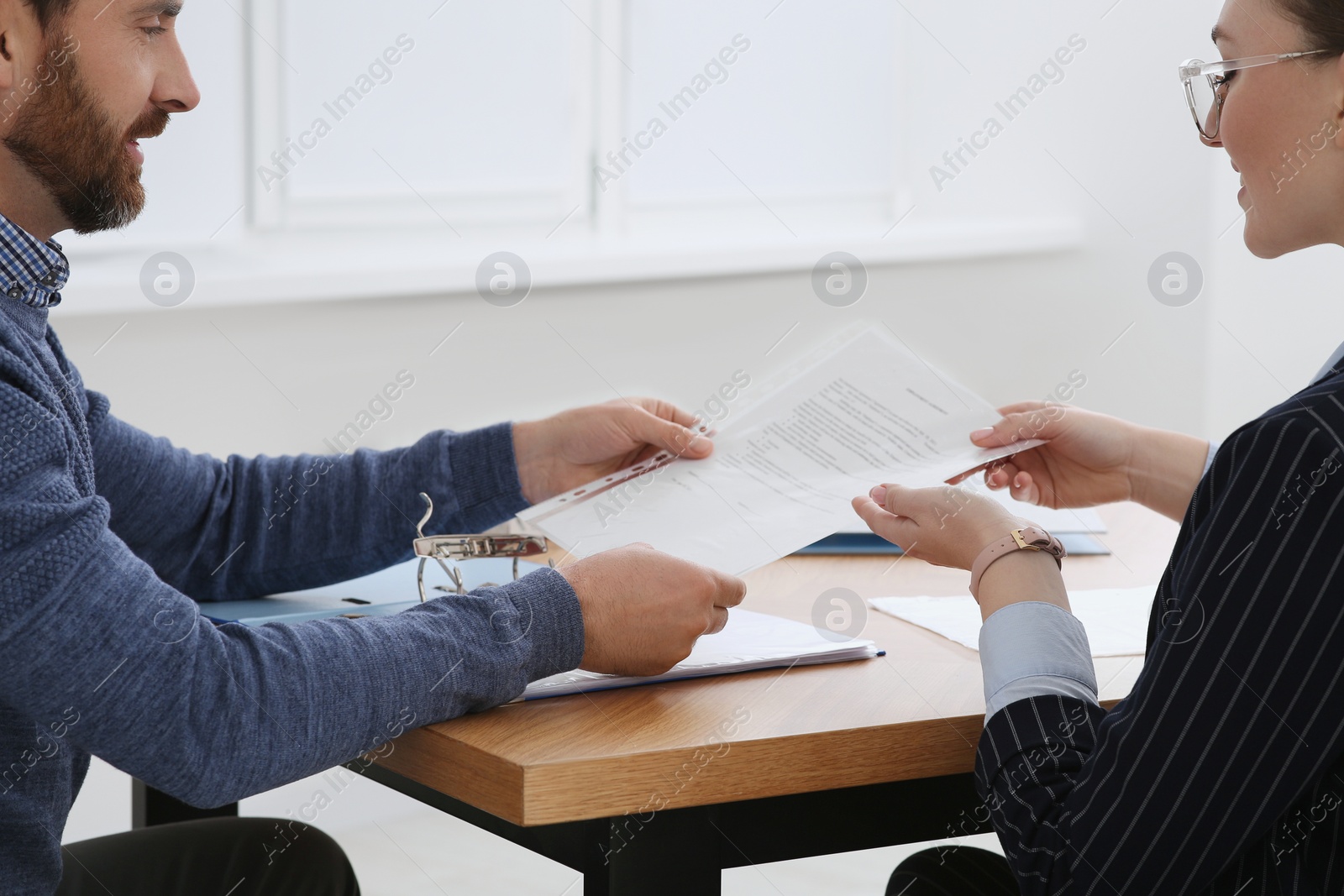 Photo of Businesspeople working with documents at wooden table in office