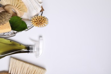 Photo of Flat lay composition with different cleaning supplies on white background, space for text