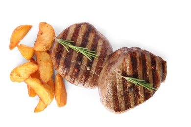 Photo of Delicious grilled beef medallions with fried potatoes isolated on white, top view
