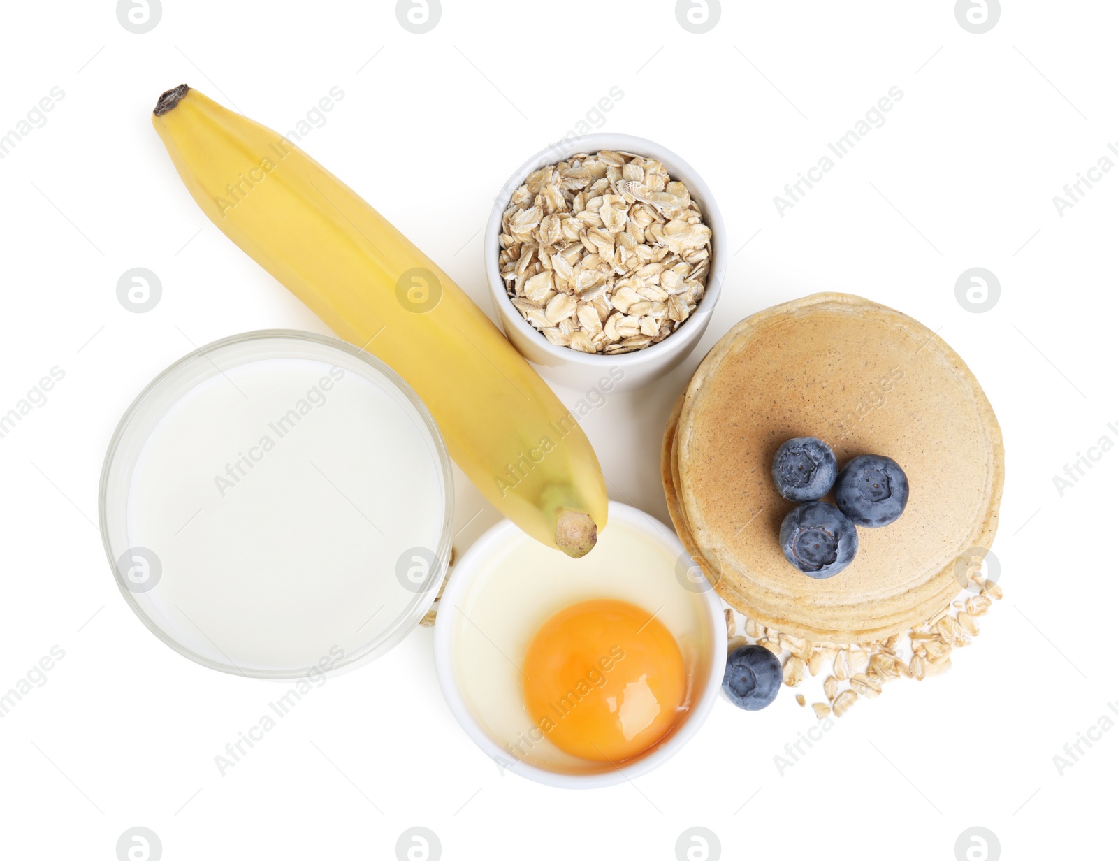 Photo of Tasty oatmeal pancakes and ingredients on white background, top view