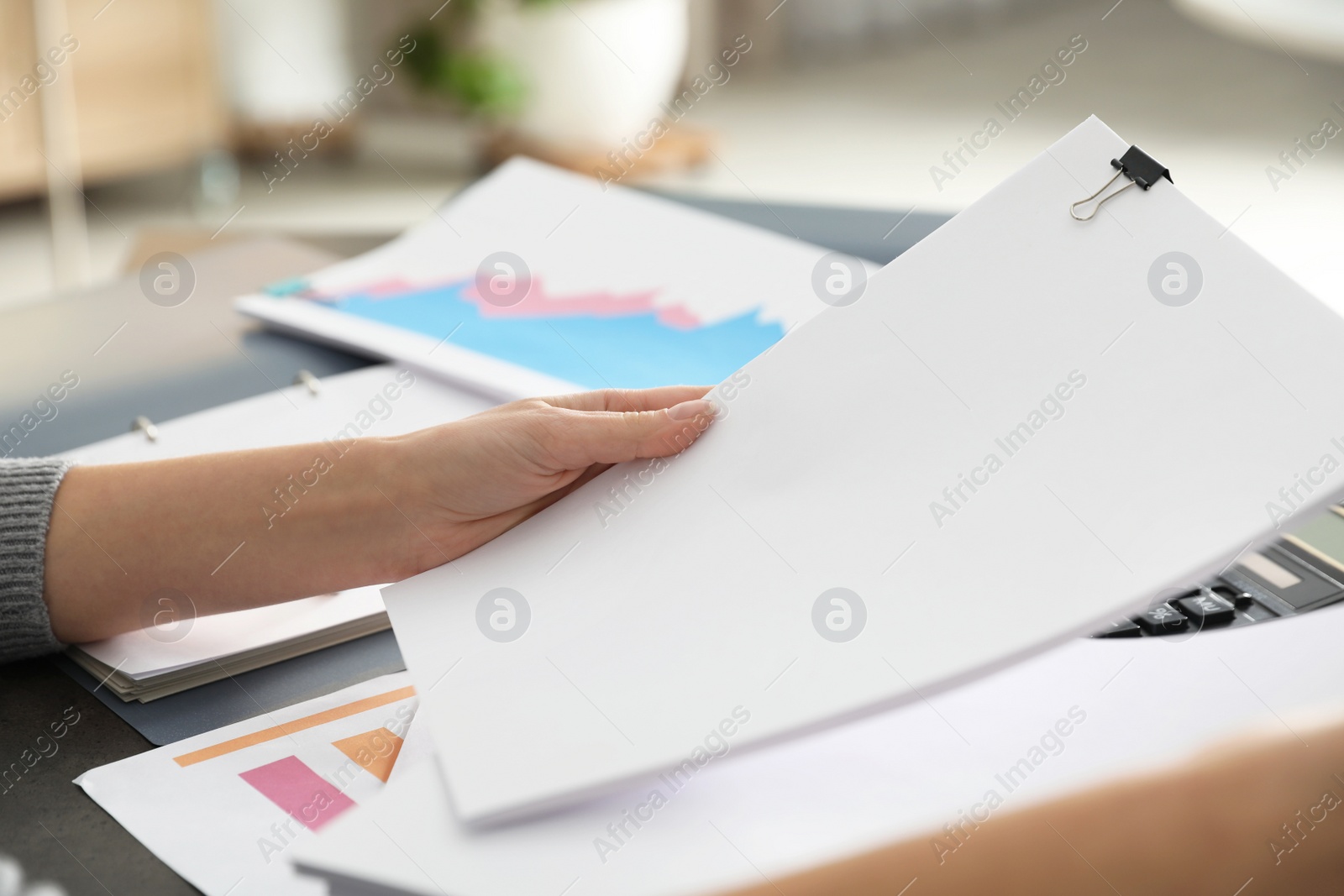 Photo of Office employee working with documents at table, closeup. Space for text