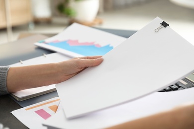 Office employee working with documents at table, closeup. Space for text