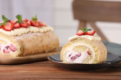 Photo of Delicious cakes roll with strawberries and cream on wooden table, space for text