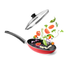 Image of Different vegetables falling into frying pan on white background. Process of cooking