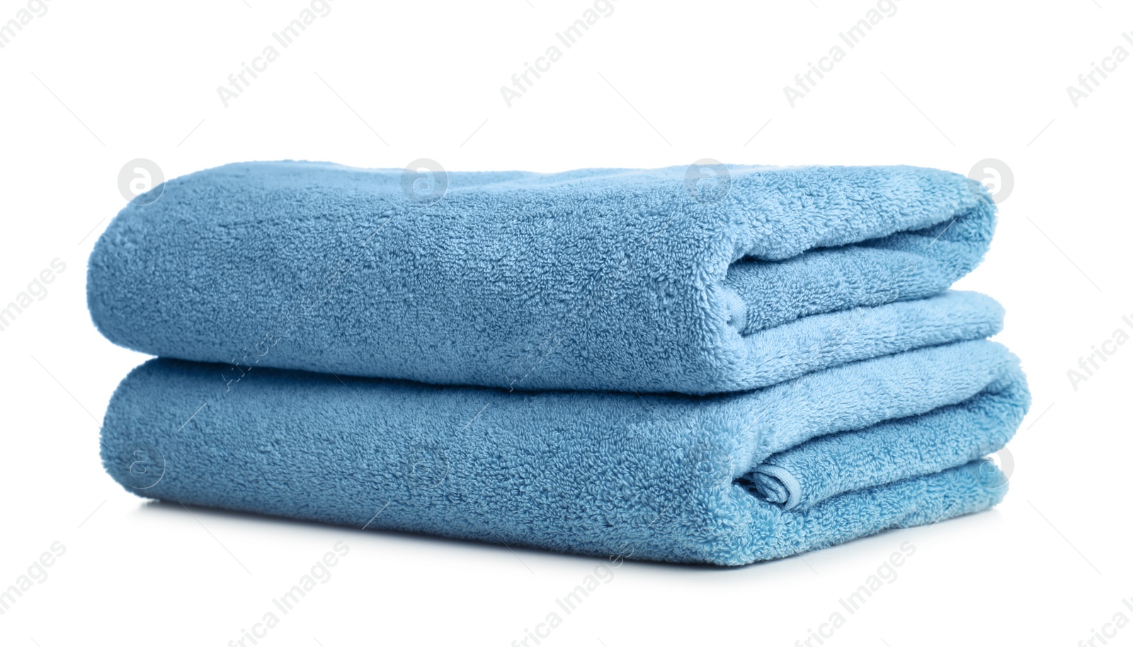 Photo of Folded soft terry towels on white background