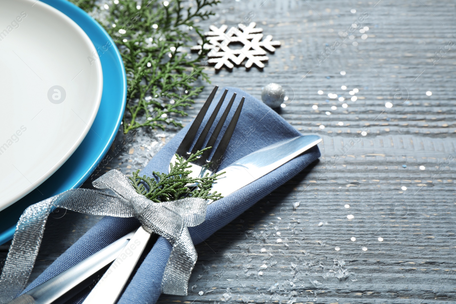 Photo of Beautiful Christmas table setting on grey wooden background, closeup