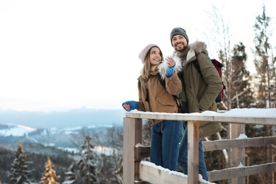 Photo of Couple spending winter vacation together in mountains. Space for text