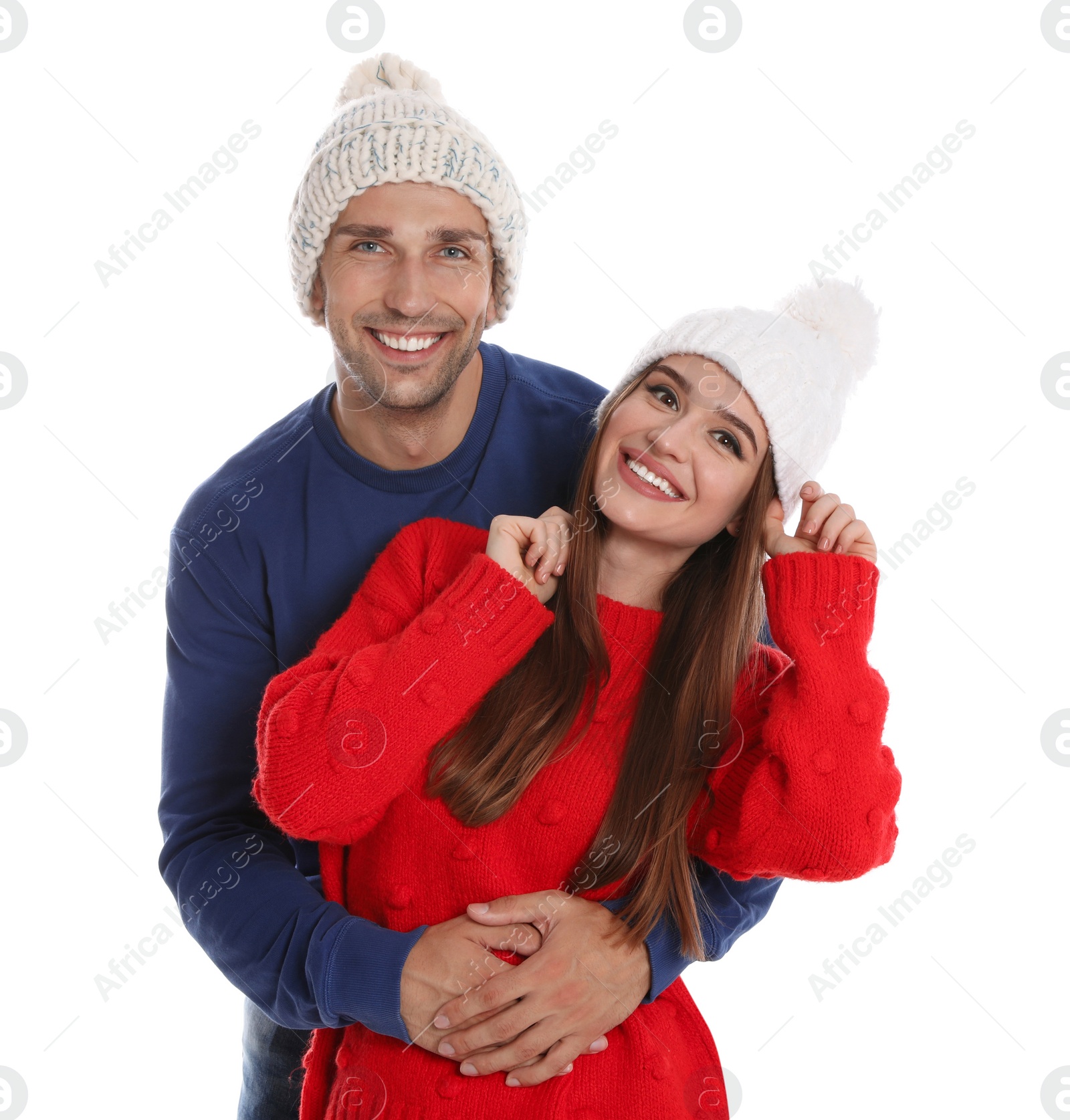 Photo of Happy young couple in warm clothes on white background. Winter season